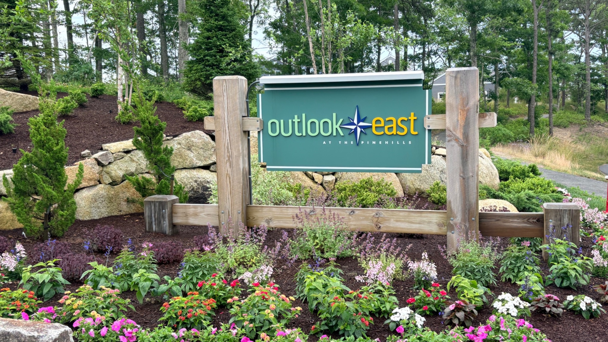 Outlook East entrance sign with summer flowers